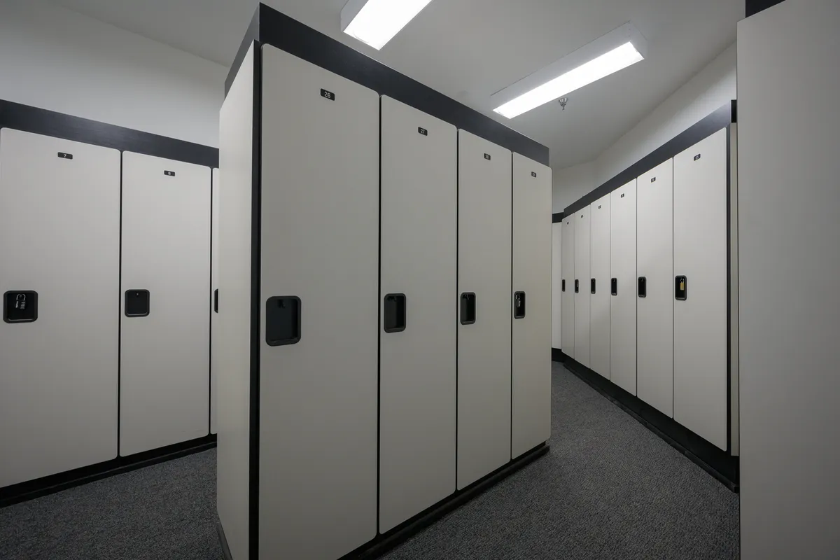 This image features a clean, minimalistic row of storage lockers, highlighted by well-lit flooring and modern light fixtures. The scene suggests secure personal storage and organization, ideal for adventure gear such as skis and bikes.